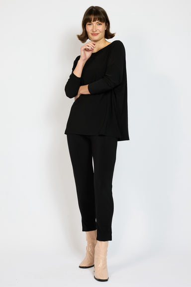 Model wearing Black Voyager Slouch Top with matching Voyager Capri Pant with Pink boots