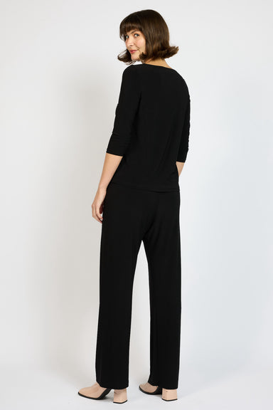 Back view of Model wearing Voyager Palazzo Pant in Black with matching Voyager 3/4 Sleeve Boat Neck Top 