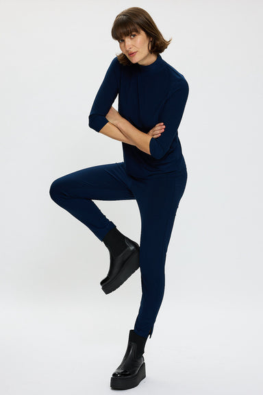 Model wearing  Navy polo top with 3/4 sleeves and matching capri pants with black boots